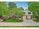Charming home with well-maintained lawn, mature trees, and attached two car garage at 9054 Cinnebar Dr, Indianapolis, IN 46268