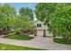 Two story home with well-maintained lawn and mature trees, has an attached garage at 9054 Cinnebar Dr, Indianapolis, IN 46268
