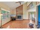 Open-concept living room features hardwood floors, fireplace, and natural light from large windows at 9054 Cinnebar Dr, Indianapolis, IN 46268