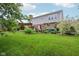 A spacious backyard with well-maintained lawn, mature trees, a deck, and a pergola, perfect for outdoor living at 9311 Windrift Way, Zionsville, IN 46077