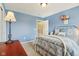 Bedroom featuring bed, window, lamp, flowers, closet, and carpet at 9311 Windrift Way, Zionsville, IN 46077