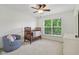 Sun-filled Bedroom with plush chair and view of nature through bright window at 9311 Windrift Way, Zionsville, IN 46077
