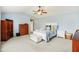 Light-filled bedroom featuring neutral walls, carpet, and ceiling fan at 9311 Windrift Way, Zionsville, IN 46077