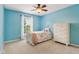 Bedroom featuring bright-blue walls, carpet, window, bed, and chest of drawers at 9311 Windrift Way, Zionsville, IN 46077
