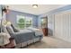 Bedroom featuring bed, window, dresser, closet, and carpet at 9311 Windrift Way, Zionsville, IN 46077