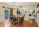 Bright dining area boasts wood floors and a modern chandelier, perfect for Gathering meals and entertaining at 9311 Windrift Way, Zionsville, IN 46077