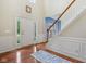 Inviting foyer with hardwood floors, a staircase, and a front door with sidelights at 9311 Windrift Way, Zionsville, IN 46077