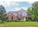 Beautiful two-story home featuring a welcoming yellow front door and lush landscaping at 9311 Windrift Way, Zionsville, IN 46077
