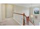 Upstairs hallway with natural lighting near the top of the staircase at 9311 Windrift Way, Zionsville, IN 46077