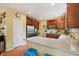 Bright kitchen with wood cabinets, neutral countertops, breakfast bar, and stainless steel appliances at 9311 Windrift Way, Zionsville, IN 46077