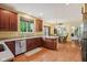 Spacious kitchen showcasing wood cabinetry, stainless steel appliances, and a clear view into the dining area at 9311 Windrift Way, Zionsville, IN 46077