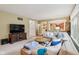 Well-lit living room featuring an open layout, comfortable seating, and views into the kitchen at 9311 Windrift Way, Zionsville, IN 46077
