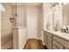 Bright bathroom showcasing a dual vanity, a glass-enclosed shower, and tile accents at 965 Astor Ln, Carmel, IN 46032