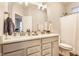 Bright bathroom with a double sink vanity, grey cabinets, white countertop and modern fixtures at 965 Astor Ln, Carmel, IN 46032