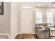 Bright entryway featuring hardwood floors and a welcoming view into the spacious living area with large windows at 965 Astor Ln, Carmel, IN 46032