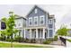 Inviting two-story home boasts a covered front porch and lush landscaping, enhancing its curb appeal in a friendly neighborhood at 965 Astor Ln, Carmel, IN 46032