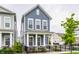 Charming two-story home featuring a welcoming front porch with classic white columns and a well-manicured front yard at 965 Astor Ln, Carmel, IN 46032