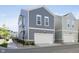 Two-story home featuring gray siding, a white garage door, and manicured landscaping at 965 Astor Ln, Carmel, IN 46032
