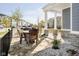 Inviting front porch enhanced with stylish stone accents, classic columns, and a cozy outdoor seating area overlooking the neighborhood at 965 Astor Ln, Carmel, IN 46032