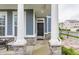 Cozy front porch with stone accents and classic columns, creating an inviting entrance with an outdoor seating area at 965 Astor Ln, Carmel, IN 46032