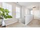 Bright upstairs hallway with large windows and a plant at 965 Astor Ln, Carmel, IN 46032