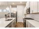 Modern kitchen featuring white cabinets, stainless steel appliances, and a large island with a sink at 965 Astor Ln, Carmel, IN 46032
