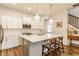 Bright, modern kitchen featuring white cabinets, stainless steel appliances, and a large island with bar seating at 965 Astor Ln, Carmel, IN 46032