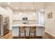Modern kitchen featuring white cabinets, stainless steel appliances, and a large island with bar seating at 965 Astor Ln, Carmel, IN 46032