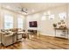 Spacious living room featuring hardwood floors, ample natural light, and stylish decor, creating a comfortable and inviting atmosphere at 965 Astor Ln, Carmel, IN 46032