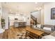 Open-concept living space showcasing a spacious kitchen and a comfortable seating area with staircase at 965 Astor Ln, Carmel, IN 46032