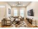 Inviting living room featuring a cozy sectional sofa, stylish coffee table, and large windows for ample natural light and comfortable living at 965 Astor Ln, Carmel, IN 46032