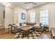 Comfortable living room featuring a gray sectional sofa, a checkered rug, and plenty of natural light at 965 Astor Ln, Carmel, IN 46032