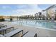 Community pool featuring lounge chairs, black metal fence, and residential homes in the background at 965 Astor Ln, Carmel, IN 46032