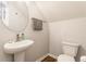 Bright powder room featuring a pedestal sink, an oval mirror, and wood-look flooring at 965 Astor Ln, Carmel, IN 46032