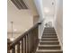 Carpeted staircase with wooden banister leading to the upper level of the home at 965 Astor Ln, Carmel, IN 46032