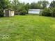 Expansive backyard featuring a shed and a garage, creating opportunities for various activities and storage at 1002 Brookside Ln, Plainfield, IN 46168