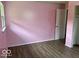 Spacious bedroom with vinyl plank flooring, a closet, and soft lighting, perfect for relaxation at 1002 Brookside Ln, Plainfield, IN 46168