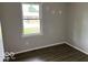 Comfortable bedroom with vinyl plank flooring and a window view, offering a versatile space at 1002 Brookside Ln, Plainfield, IN 46168