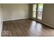 Bright living room featuring large windows and vinyl plank flooring, creating a warm, inviting space at 1002 Brookside Ln, Plainfield, IN 46168