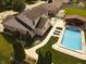 Relaxing backyard featuring a pool, outdoor kitchen, and lounge chairs, perfect for entertaining guests at 1026 Summer Way Dr, Shelbyville, IN 46176