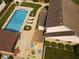 A private backyard featuring an in-ground pool, outdoor kitchen, fire pit, lounge chairs, and green landscaping at 1026 Summer Way Dr, Shelbyville, IN 46176