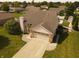 Beautiful home with an attached two-car garage, brick chimney, and well-maintained lawn at 1026 Summer Way Dr, Shelbyville, IN 46176