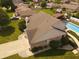 Aerial view of a home featuring a brick exterior and a swimming pool with a black fence at 1026 Summer Way Dr, Shelbyville, IN 46176