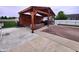 Relax in this backyard with a covered pool, wooden pergola, basketball hoop, and outdoor kitchen, perfect for entertaining guests at 1026 Summer Way Dr, Shelbyville, IN 46176
