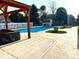 Backyard with a pool, pool house, and stamped concrete patio at 1026 Summer Way Dr, Shelbyville, IN 46176