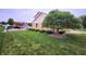 A lush green yard has trimmed bushes by the home plus an outdoor patio at 1026 Summer Way Dr, Shelbyville, IN 46176