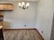Charming dining area with light wood floors and chandelier at 1026 Summer Way Dr, Shelbyville, IN 46176