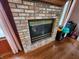 Living room fireplace with brick surround and black and gold trim at 1026 Summer Way Dr, Shelbyville, IN 46176