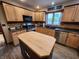 Full kitchen view with wooden cabinetry, tile backsplash, and a large island at 1026 Summer Way Dr, Shelbyville, IN 46176