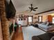 Cozy living room with a brick fireplace, hardwood floors, and neutral decor at 1026 Summer Way Dr, Shelbyville, IN 46176